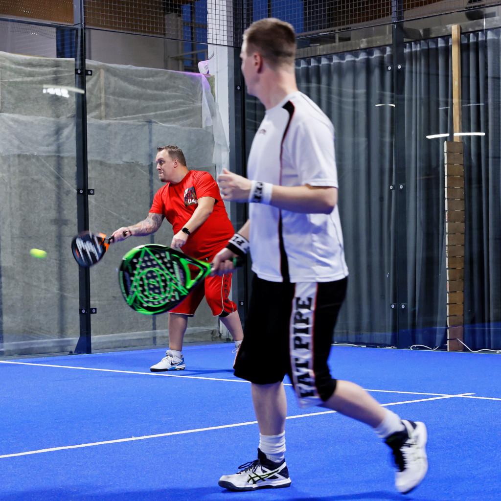 Two men playing padel.